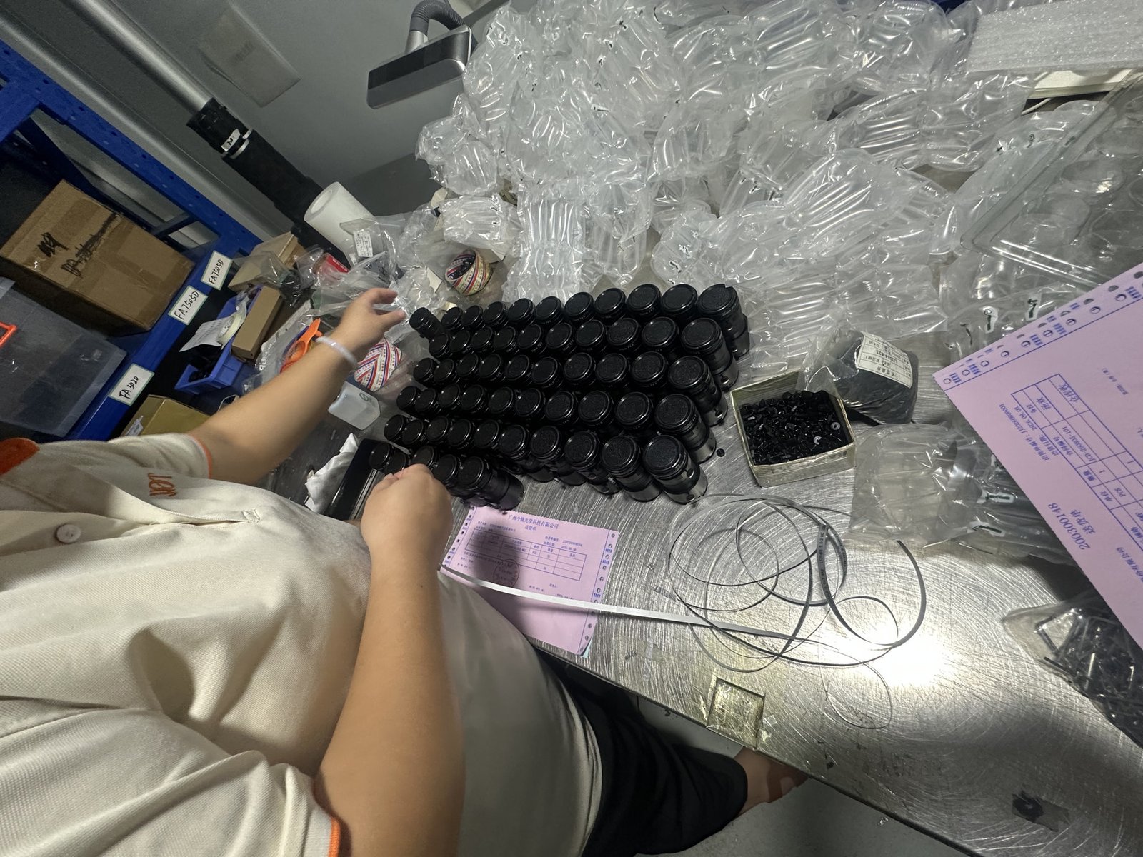 Lensmind technician assembling a batch of FA machine vision lenses at the workbench